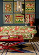 Maximalist interior with vibrant patterns, featuring the Carnival Cirque en Fleur upholstered sofa and a Rick Rack lampshade on a table lamp behind. Photography by Sophia Spring.